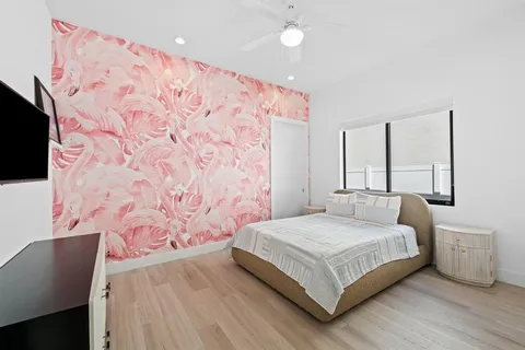 a bedroom with a bed and a flat screen tv