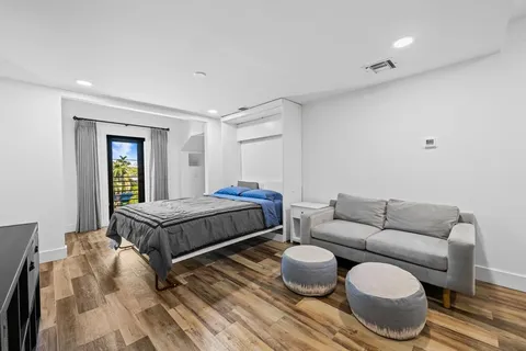 a bedroom with a bed and a couch