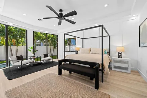 a bedroom with a bed couch and window