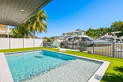 a view of a swimming pool with an outdoor seating and a yard