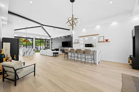 a living room with furniture a flat screen tv and a table