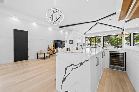 a very nice looking room with a large window and furniture