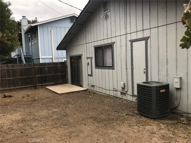 a view of backyard with barbeque grill wooden floor and fence