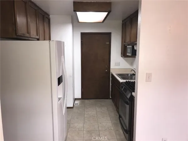 a walk in closet with wooden floor
