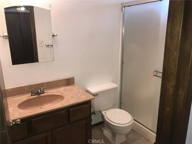 a bathroom with a sink toilet and mirror