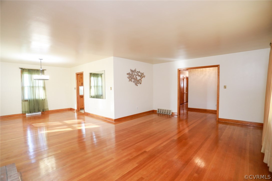 1102 Arlington Road Hopewell, VA 23860 - Photo 20 of 50 a view of an empty room with wooden floor and a window