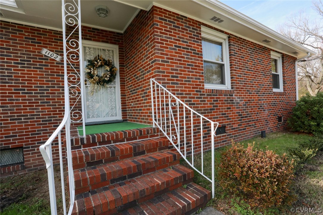 1102 Arlington Road Hopewell, VA 23860 - Photo 7 of 50 a view of a house with a small yard and potted plants