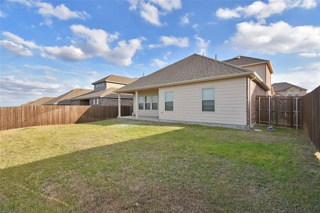 a view of a house with a backyard