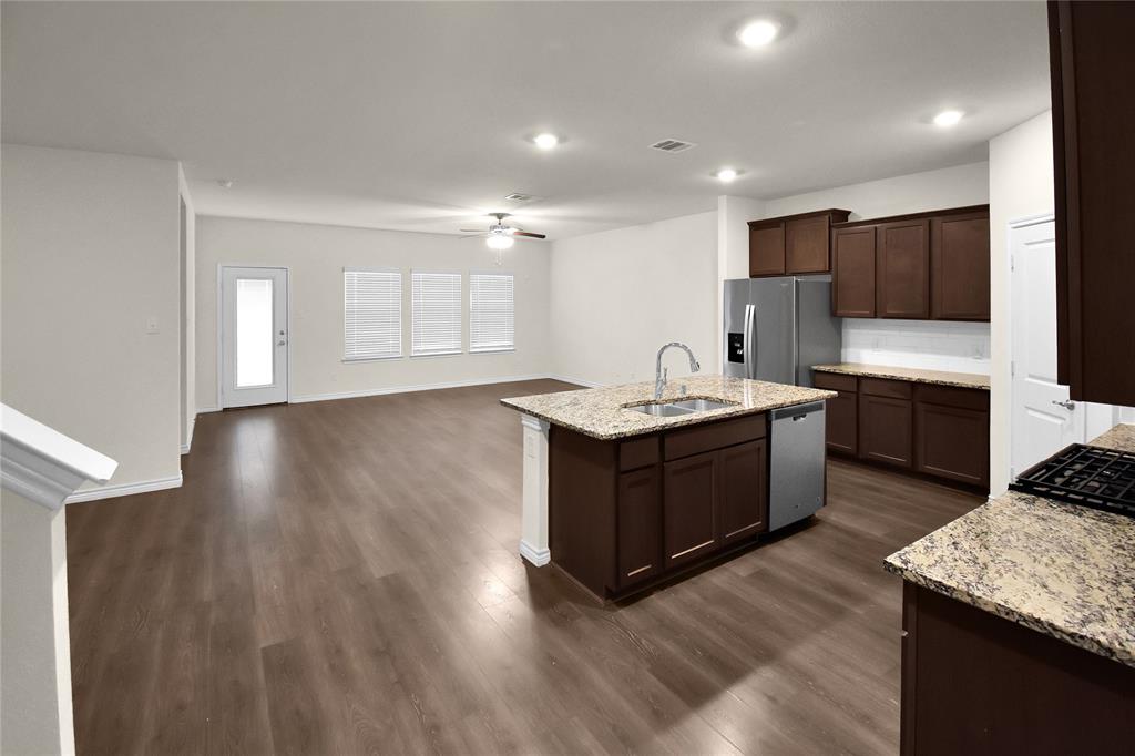 604 Gunsmoke Trail Princeton, TX 75407 - Photo 8 of 25 a kitchen with a sink cabinets and wooden floor