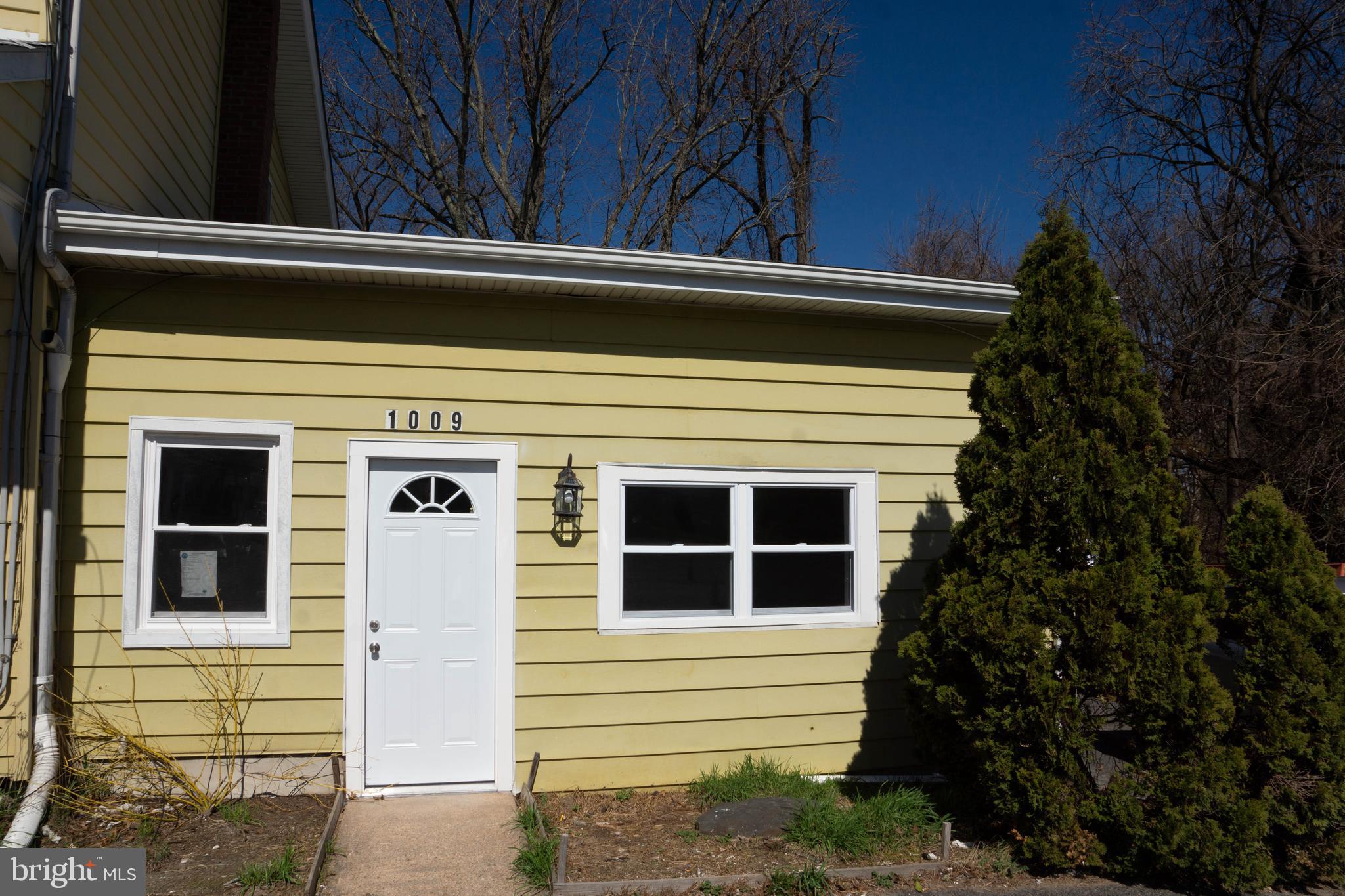 1009 Main Street, Unit 1 Fallston, MD 21047 - Photo 19 of 19 a view of a house with a large window and flower plants