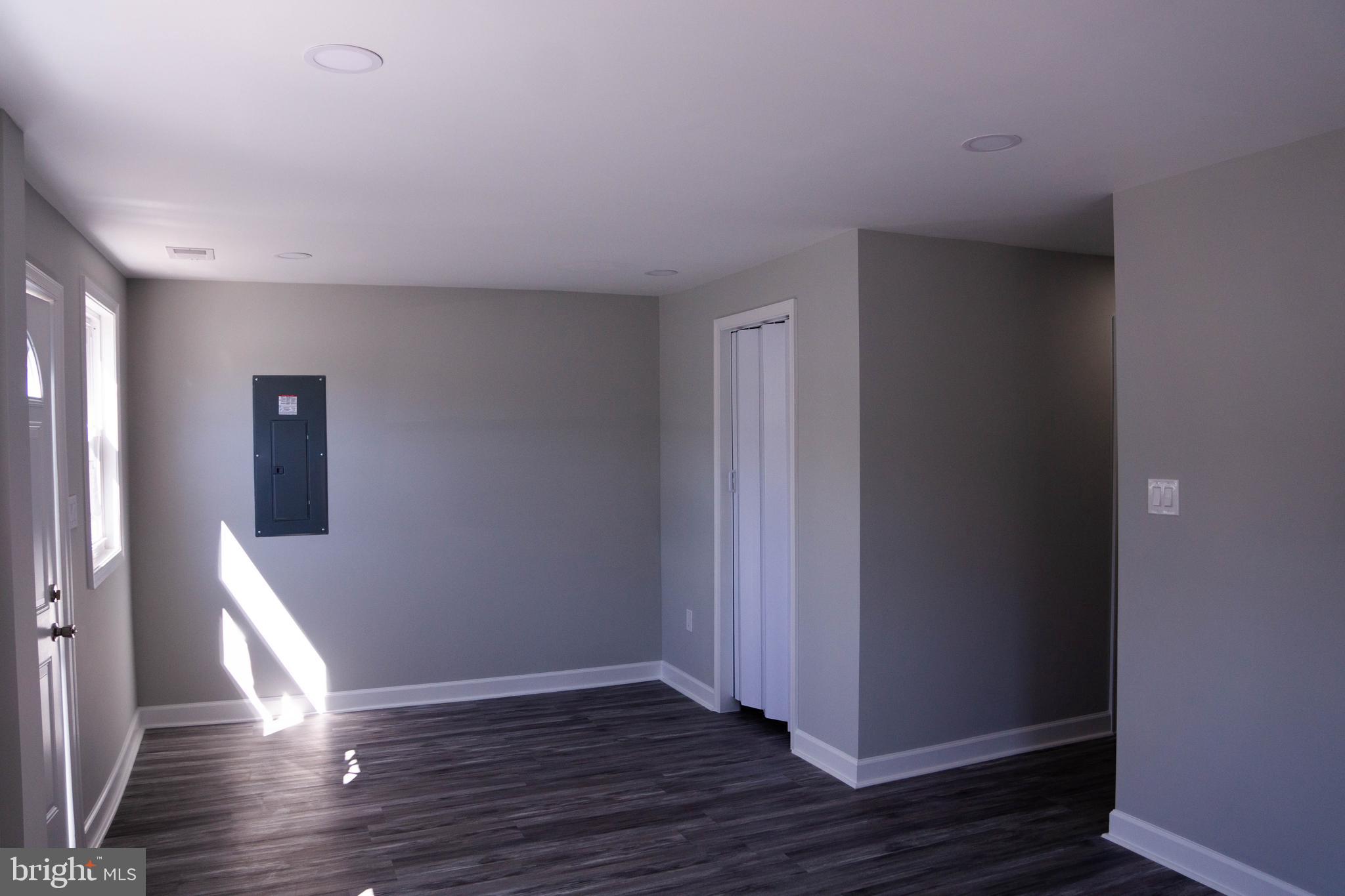 1009 Main Street, Unit 1 Fallston, MD 21047 - Photo 2 of 19 a view of an empty room with wooden floor and a window