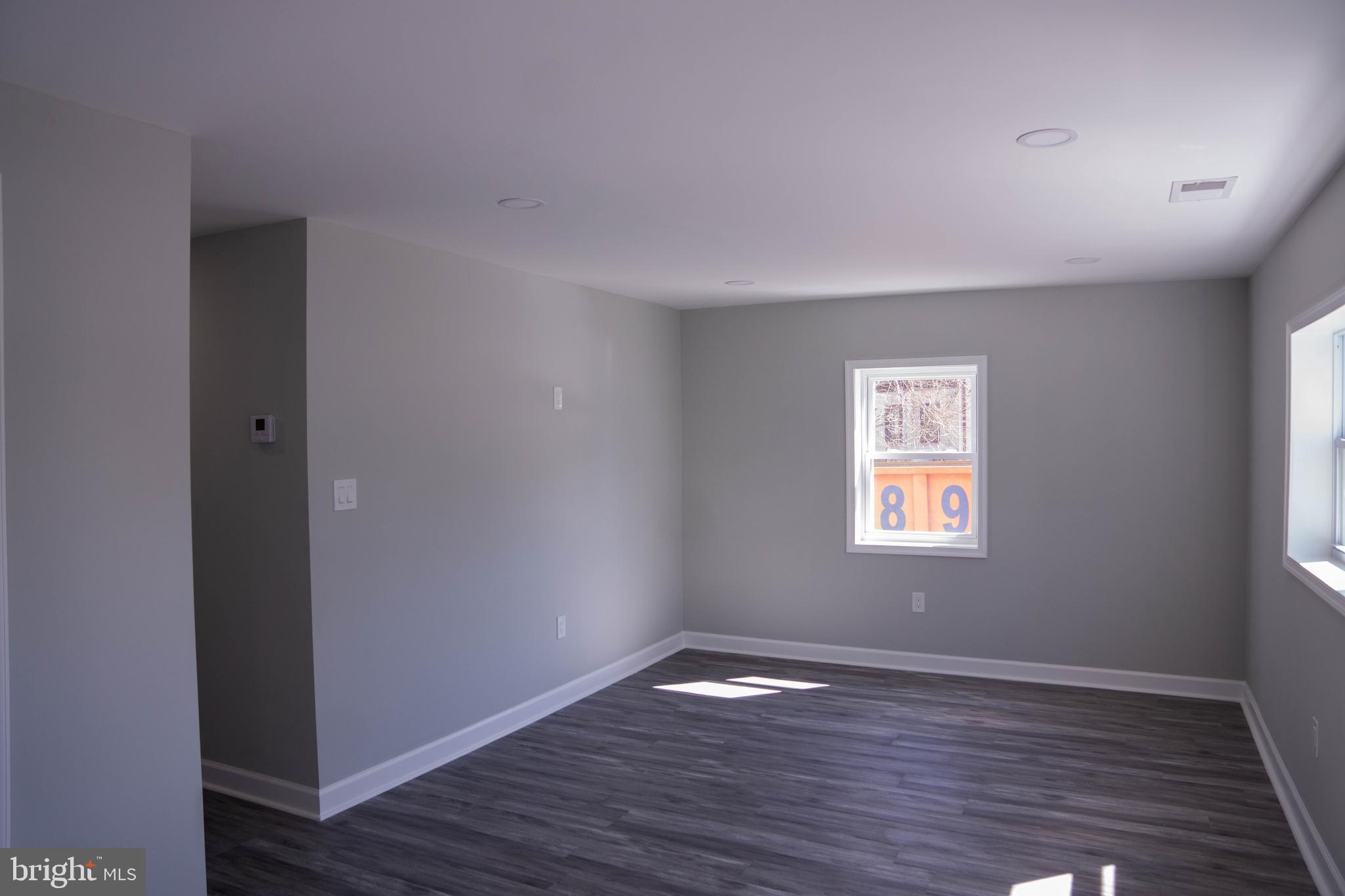 1009 Main Street, Unit 1 Fallston, MD 21047 - Photo 3 of 19 a view of an empty room with wooden floor and a window