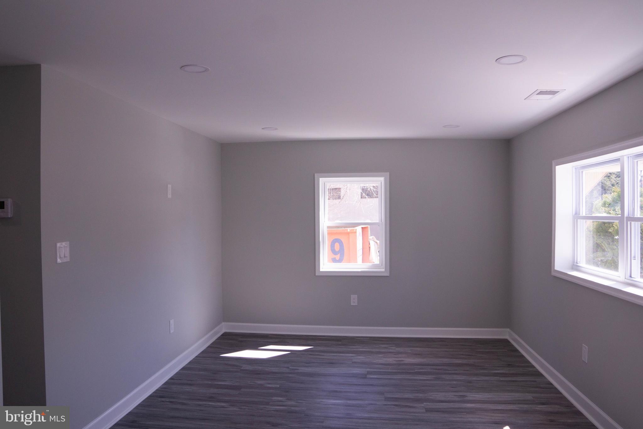 1009 Main Street, Unit 1 Fallston, MD 21047 - Photo 5 of 19 an empty room with wooden floor and windows
