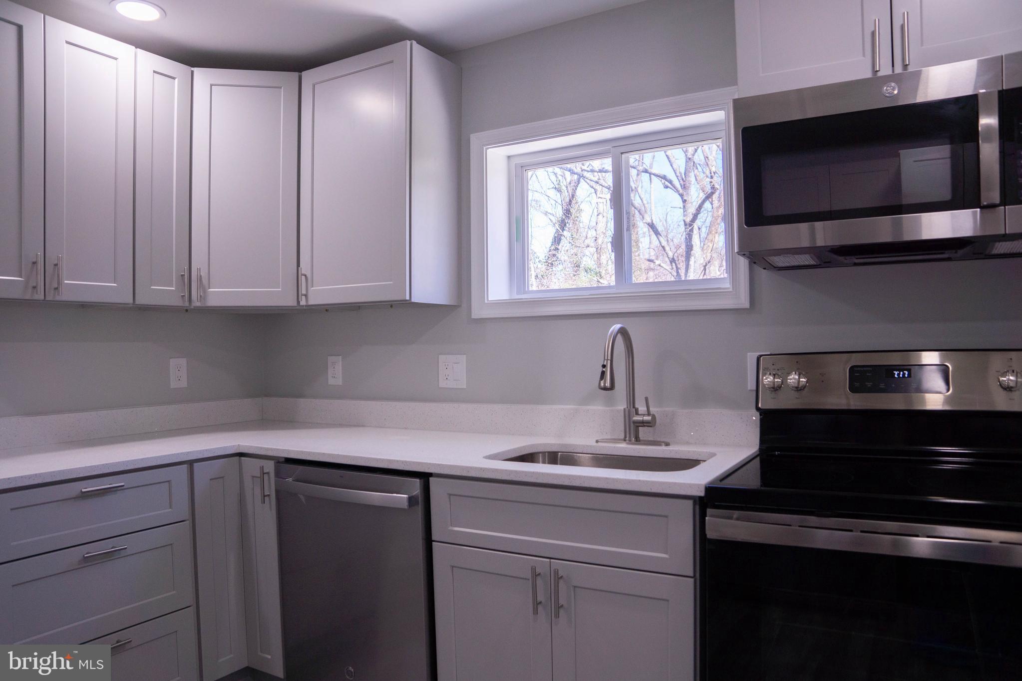 1009 Main Street, Unit 1 Fallston, MD 21047 - Photo 10 of 19 a kitchen with a sink stove and microwave
