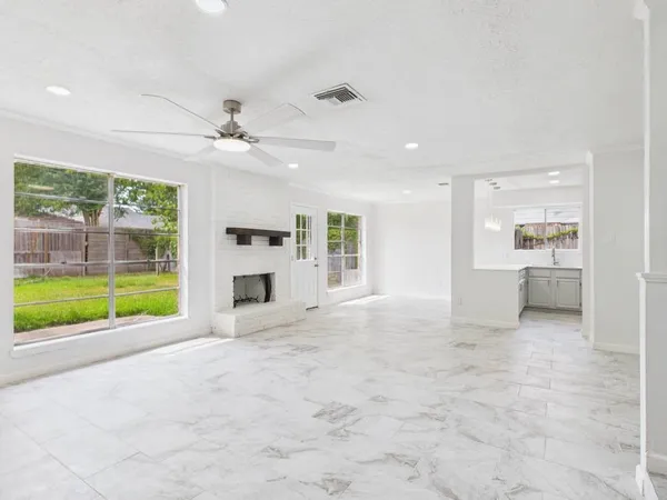 a view of a kitchen with a sink and a fireplace
