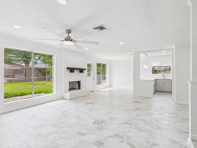 a view of a kitchen with a sink and a fireplace