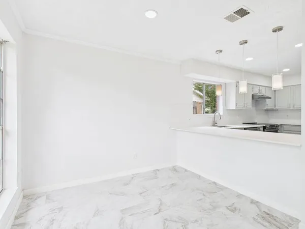 a kitchen with a sink cabinets and window