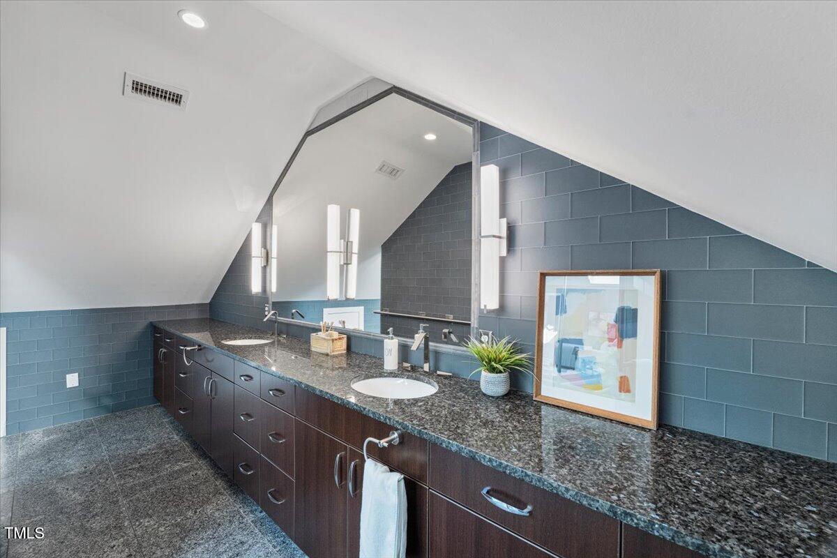 255 Penley Circle Raleigh, NC 27609 - Photo 17 of 35 a bathroom with a granite countertop double vanity sink and a mirror