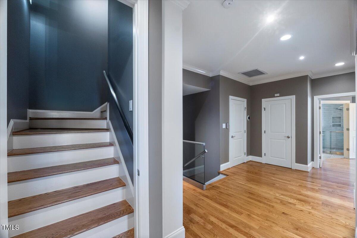 255 Penley Circle Raleigh, NC 27609 - Photo 19 of 35 a view of a hallway with wooden floor and entryway