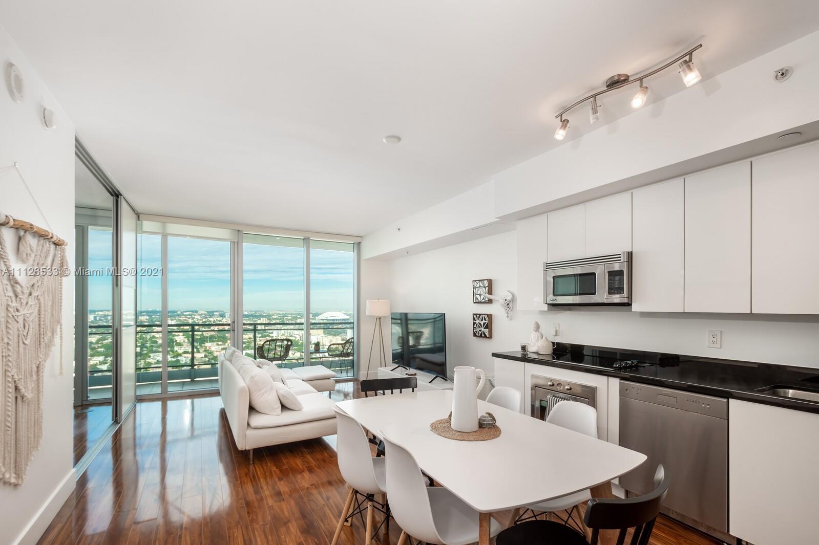 92 Southwest 3rd Street, Unit 3507 Miami, FL 33130 - Photo 1 of 12 a living room with furniture flat screen tv and a large window