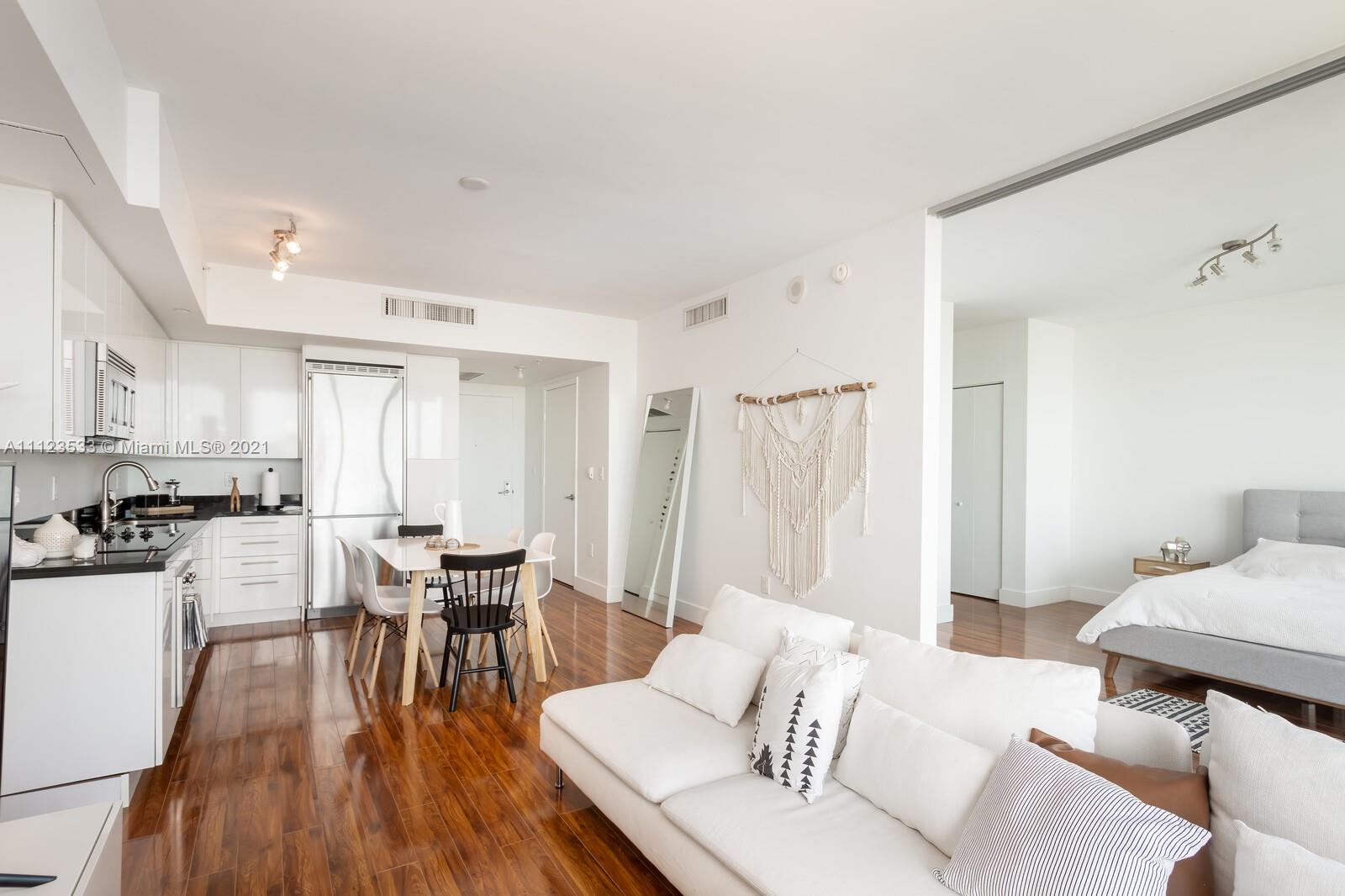 92 Southwest 3rd Street, Unit 3507 Miami, FL 33130 - Photo 3 of 12 a living room with furniture and wooden floor