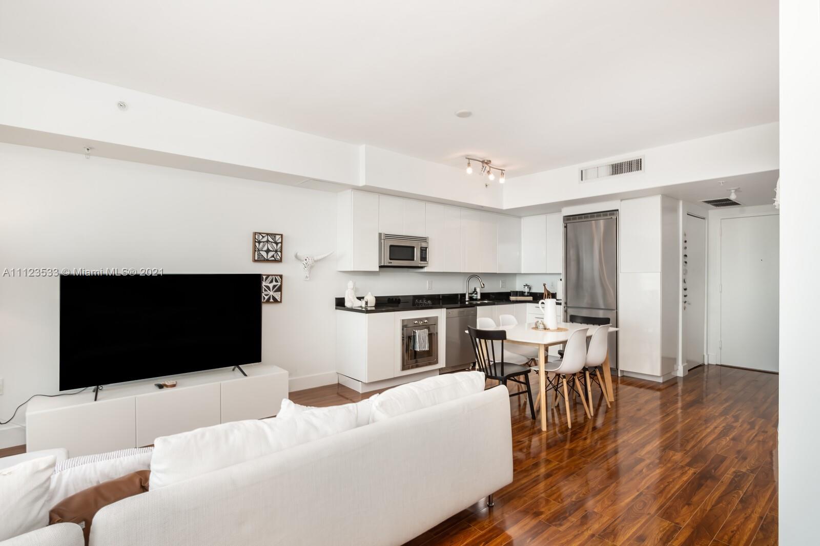 92 Southwest 3rd Street, Unit 3507 Miami, FL 33130 - Photo 4 of 12 a living room with furniture and a flat screen tv