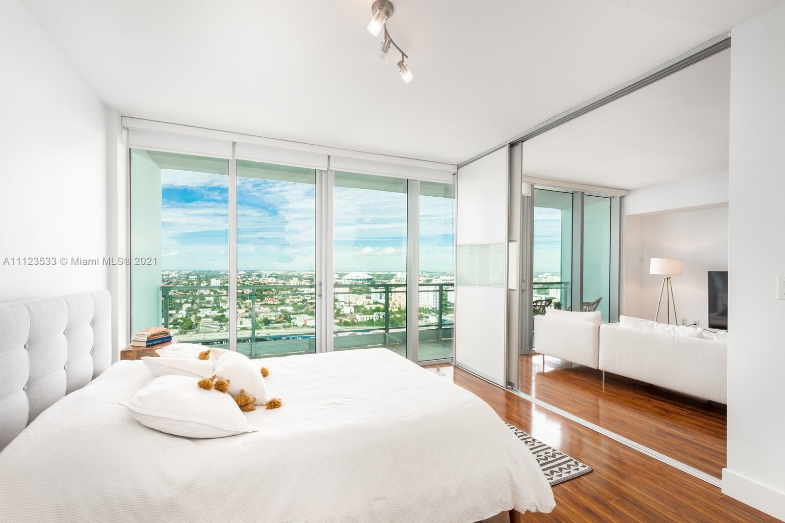 92 Southwest 3rd Street, Unit 3507 Miami, FL 33130 - Photo 6 of 12 a bedroom with a bed and large window