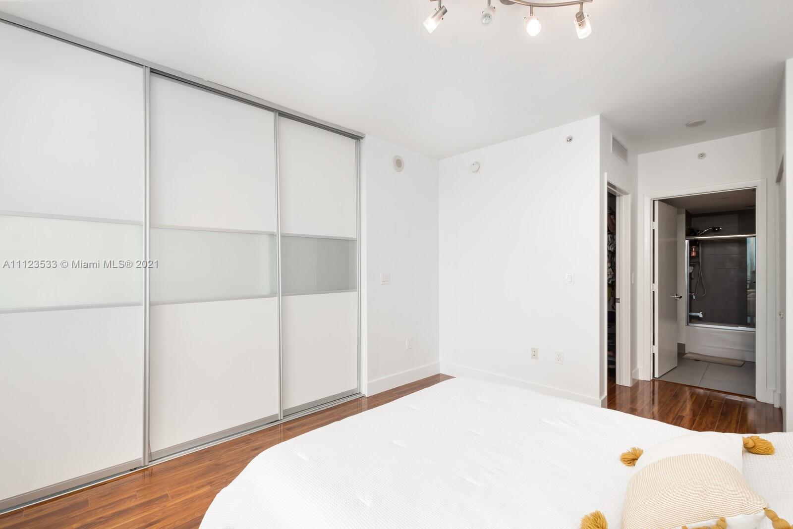 92 Southwest 3rd Street, Unit 3507 Miami, FL 33130 - Photo 7 of 12 a bedroom with a bed and a cabinet