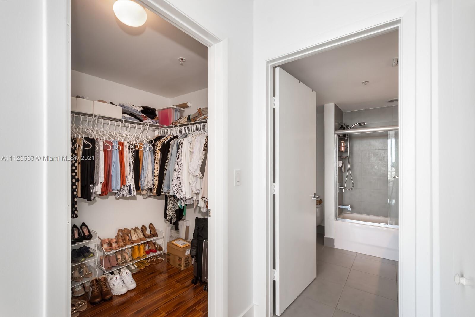 92 Southwest 3rd Street, Unit 3507 Miami, FL 33130 - Photo 8 of 12 a view of walk in closet with clothes and shoes