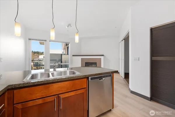 a kitchen with kitchen island a counter space and a refrigerator