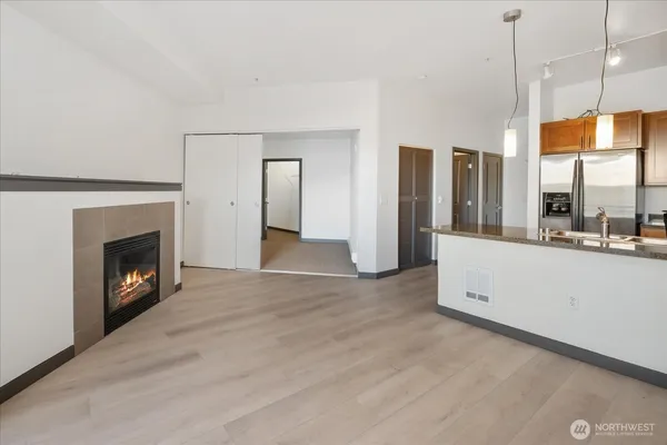 a view of an empty room with a fireplace and a window