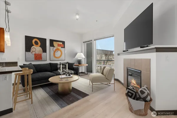a living room with furniture a flat screen tv and a fireplace