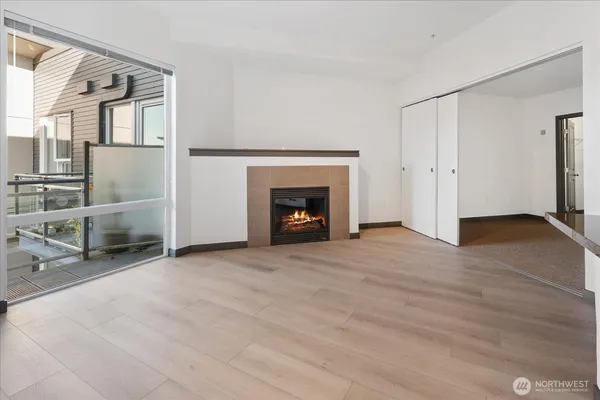 a view of an empty room with fire place and a fireplace