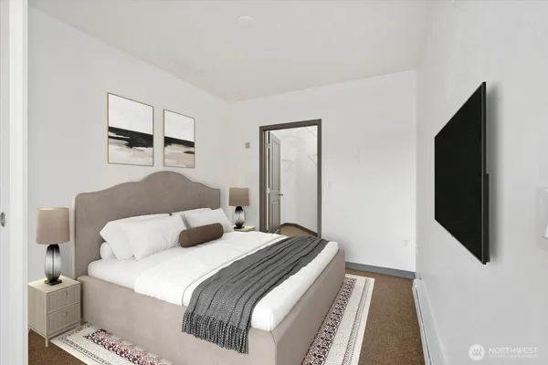 a bedroom with a bed and a flat screen tv