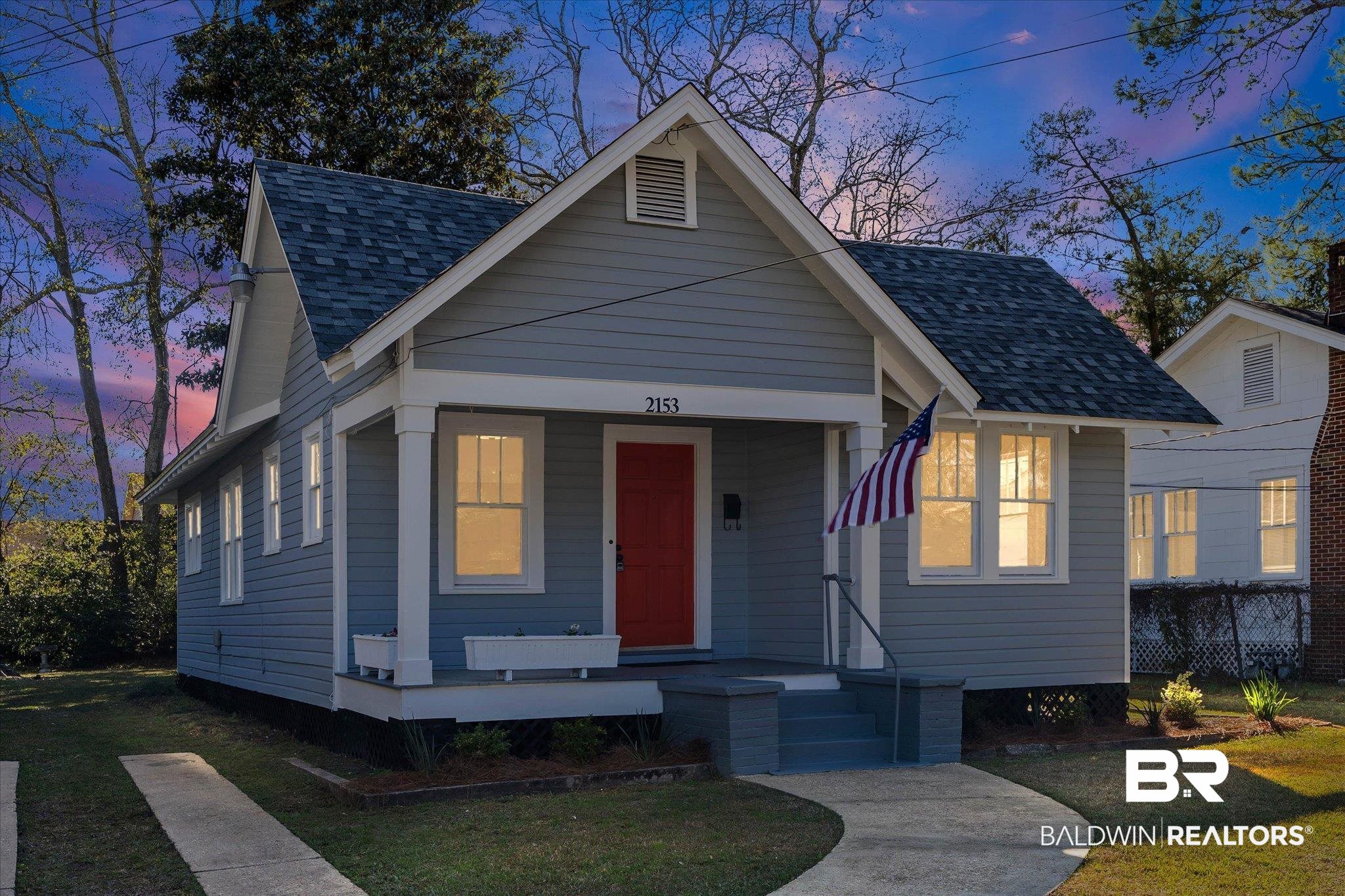 2153 Old Government Street Mobile, AL 36606 - Photo 22 of 23 View of front facade with a front lawn, covered porch, and a shingled roof