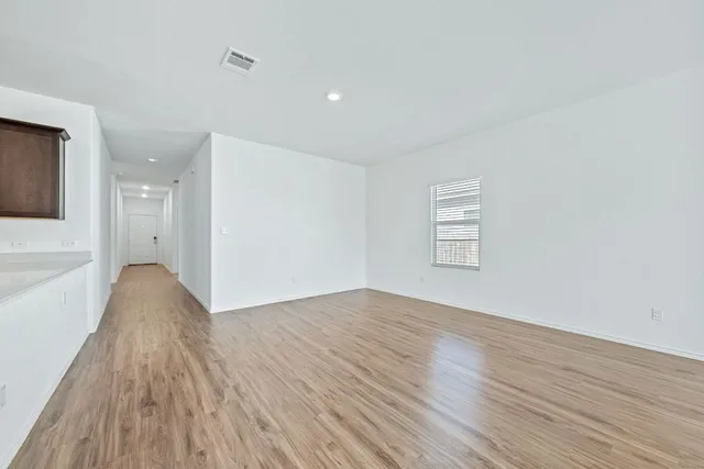 a kitchen with granite countertop a refrigerator stove and sink