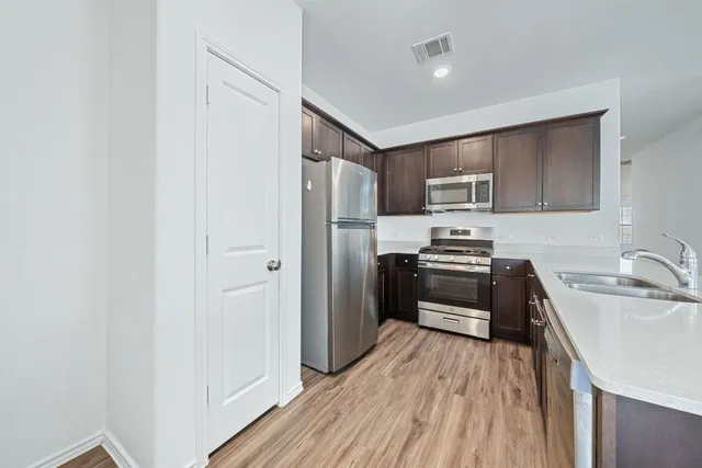 a view with cabinets and wooden floor