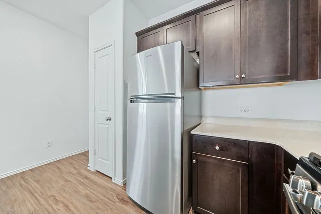 a kitchen with metallic refrigerator freezer and a dishwasher