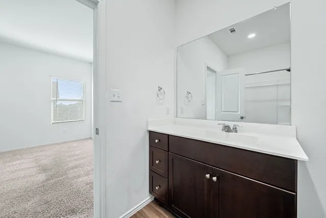 a bathroom with a sink a mirror and a toilet