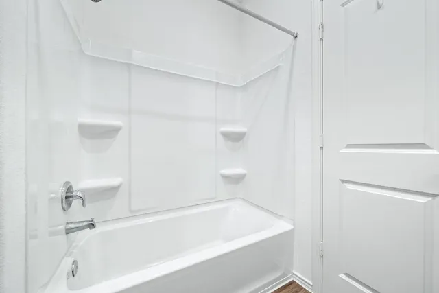 a bathroom with a bathtub and a toilet