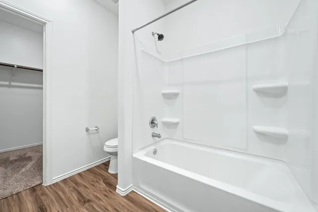 a bathroom with a bathtub and a toilet