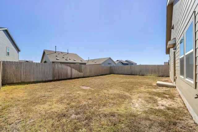 a view of parking space with wooden fence