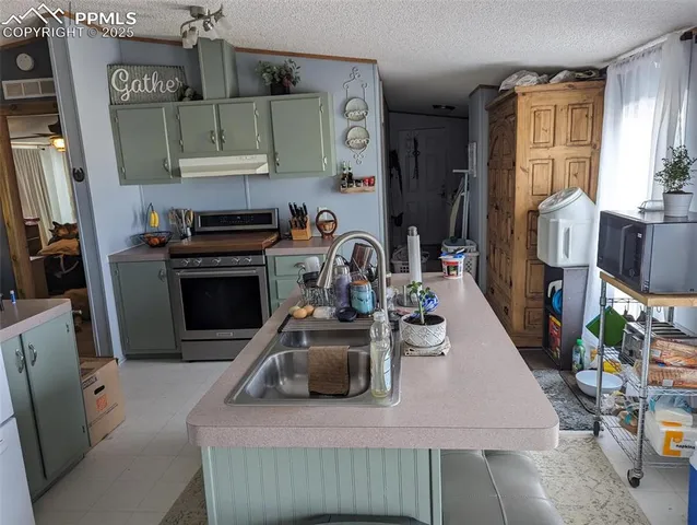 a kitchen with a sink stove and cabinets