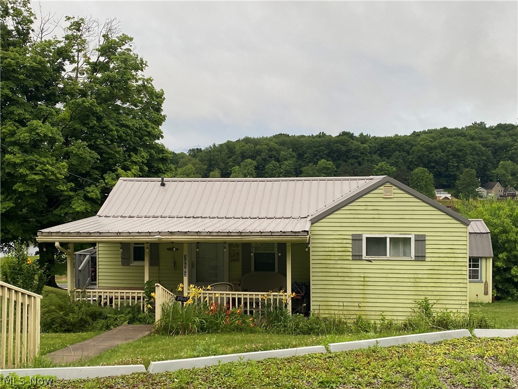 View of front facade with a front yard and covered porch