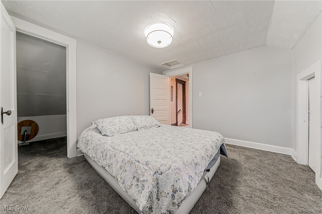 13614 Granger Road Cleveland, OH 44125 - Photo 16 of 38 Bedroom with carpet floors, attic access, and a textured ceiling
