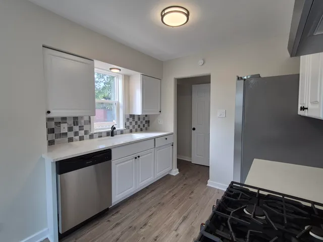 a spacious bathroom with a double vanity sink a mirror and a shower