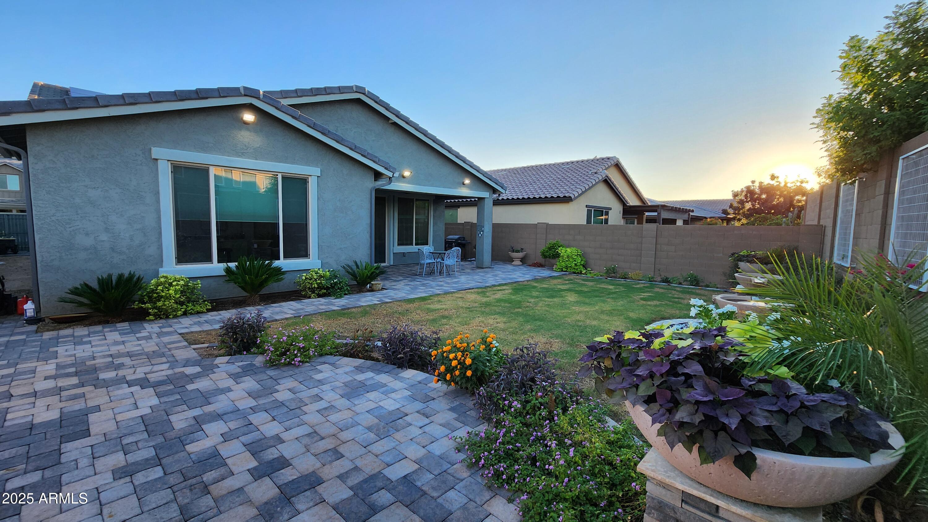 14400 West Bloomfield Road Surprise, AZ 85379 - Photo 15 of 38 a front view of a house with a yard and potted plants