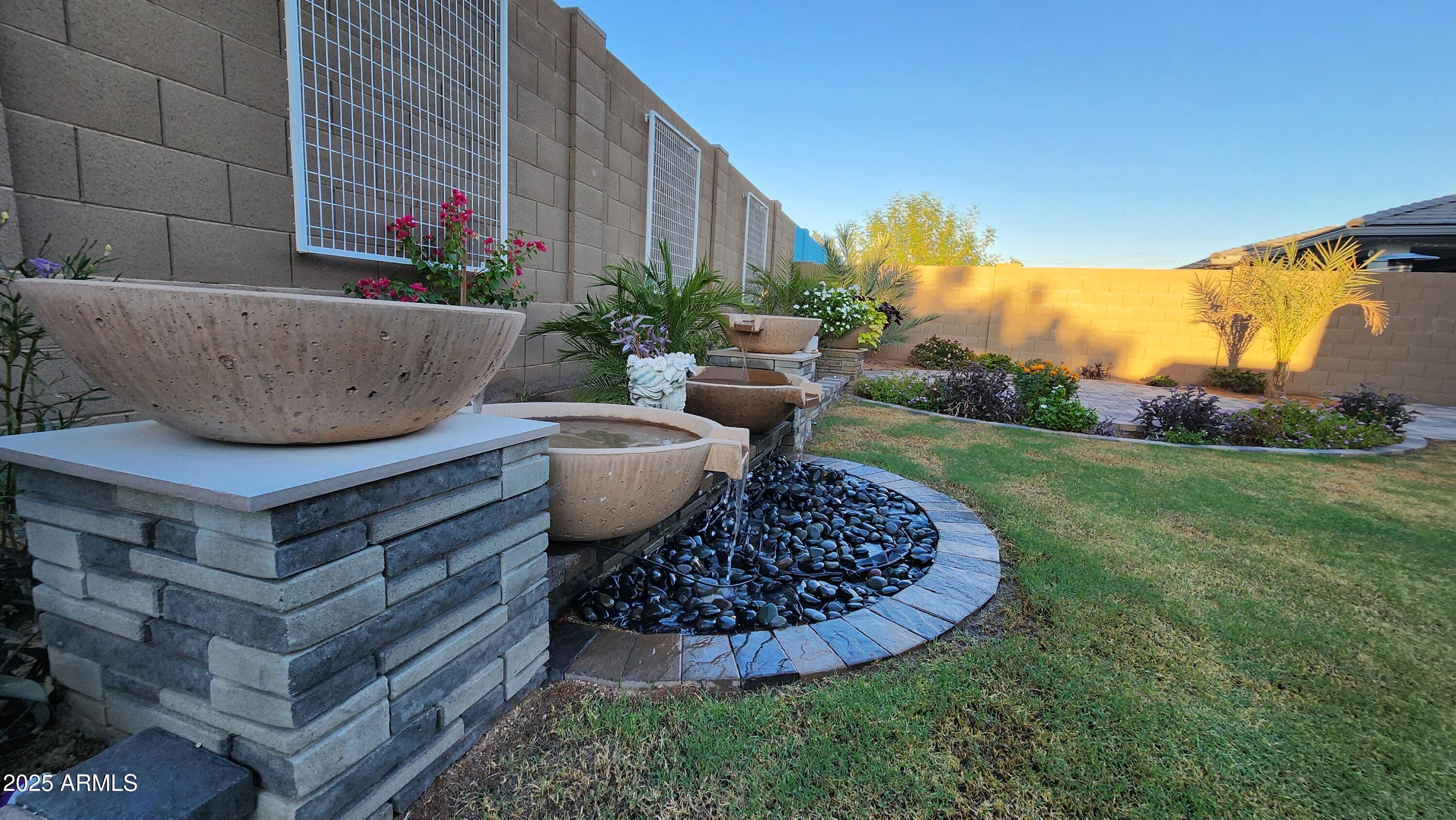 14400 West Bloomfield Road Surprise, AZ 85379 - Photo 17 of 38 a view of a backyard with plants and a tub
