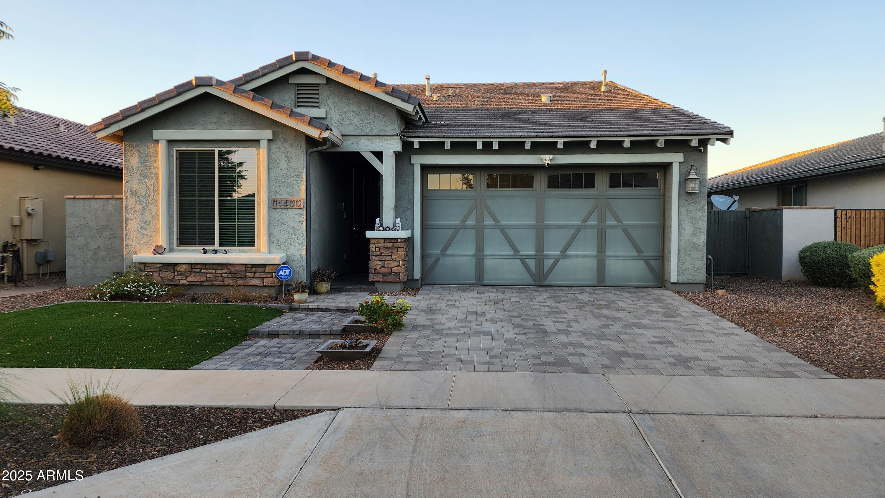 14400 West Bloomfield Road Surprise, AZ 85379 - Photo 20 of 38 a front view of a house with a yard and garage