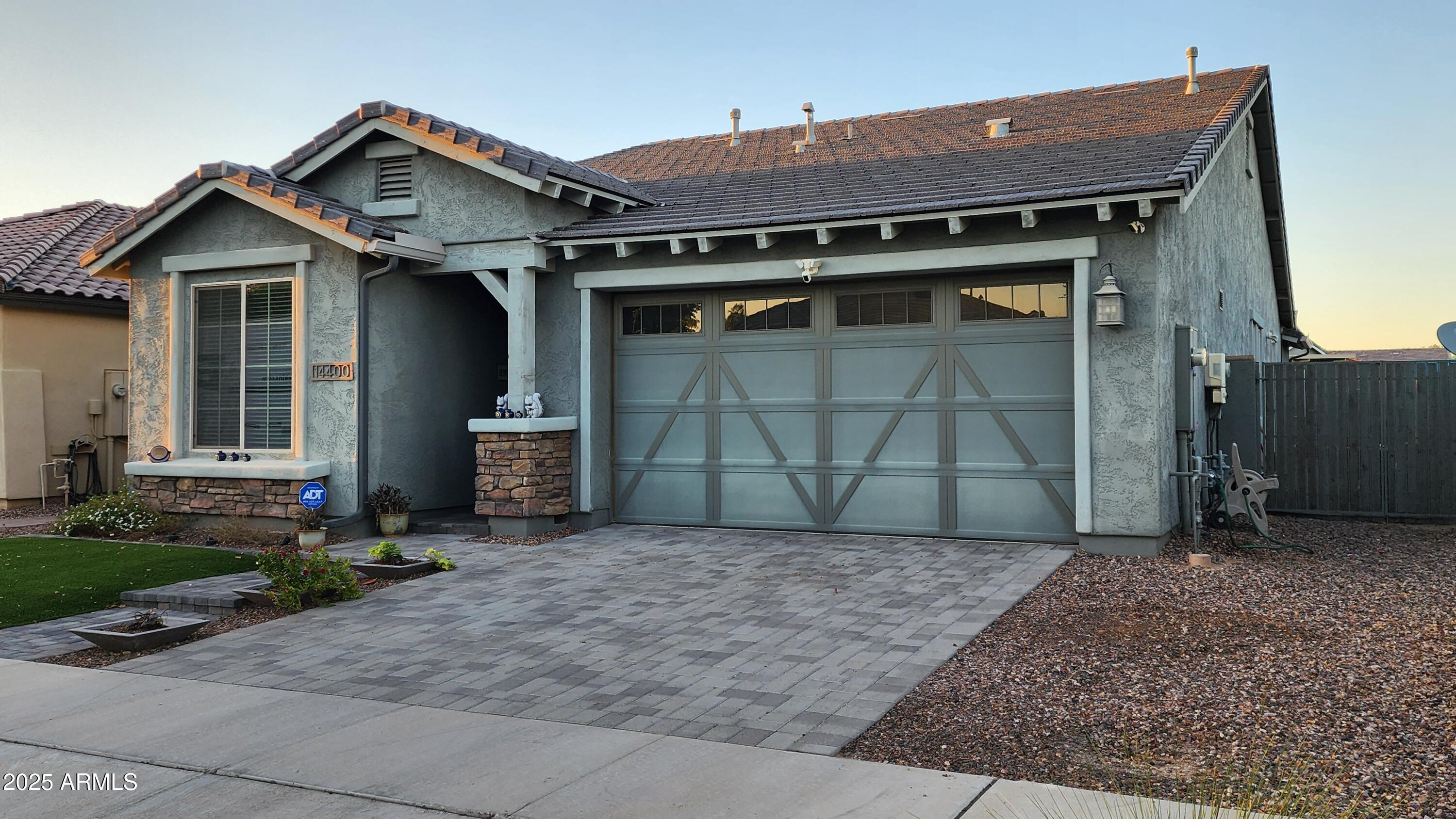 14400 West Bloomfield Road Surprise, AZ 85379 - Photo 22 of 38 a front view of a house with a yard and garage